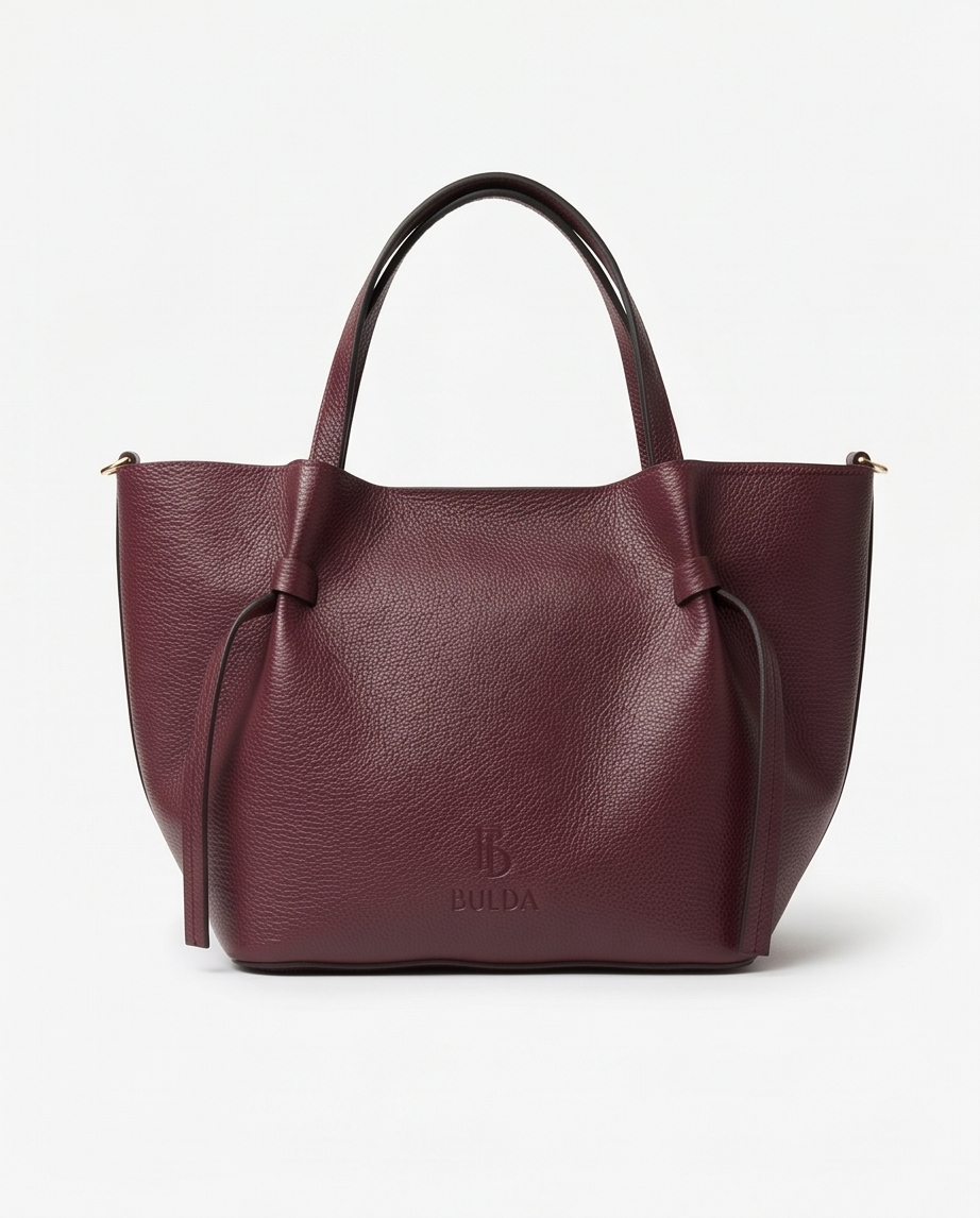 High-resolution product photo of a burgundy tote bag with minimalist/tote details.