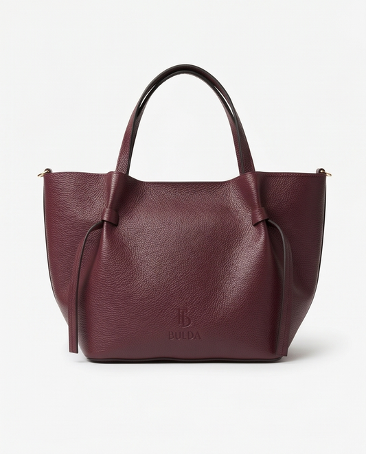 High-resolution product photo of a burgundy tote bag with minimalist/tote details.
