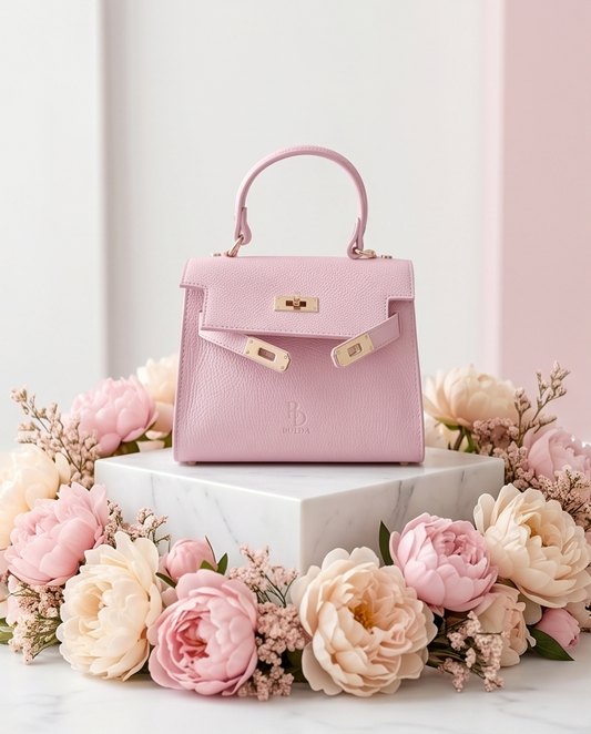 Soft powder pink leather handbag with top handle, handcrafted in Prato, Tuscany, elegant feminine design.